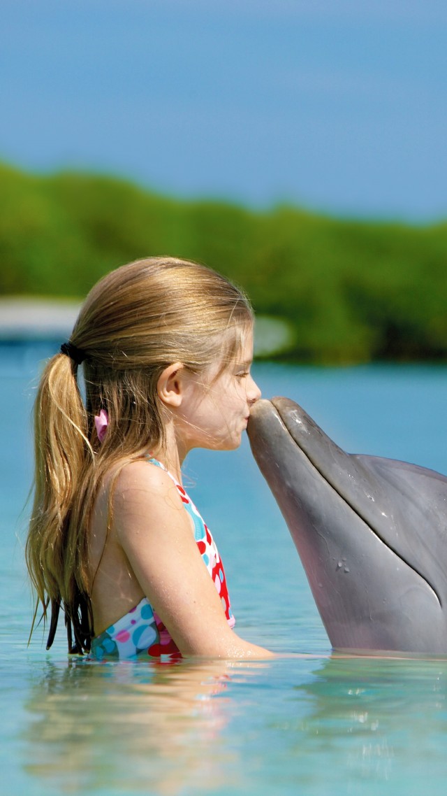 Girl and dolphin, ocean, Maldives (vertical)