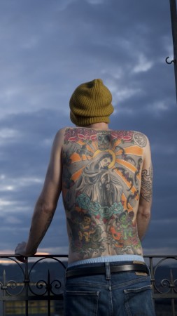 Tim Steiner, tattoo, Virgin Mary, skull, roses, swallows, lotus (vertical)