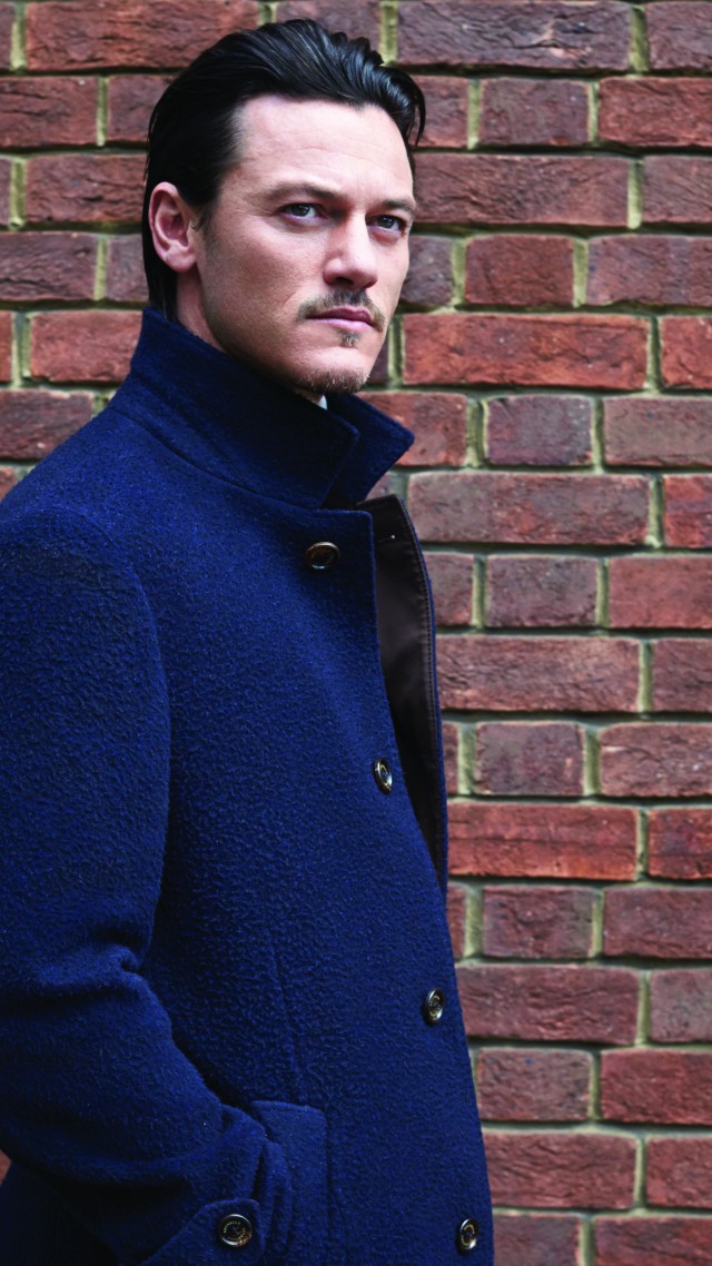 Luke Evans, Actor, blue cloak, brick wall, look (vertical)